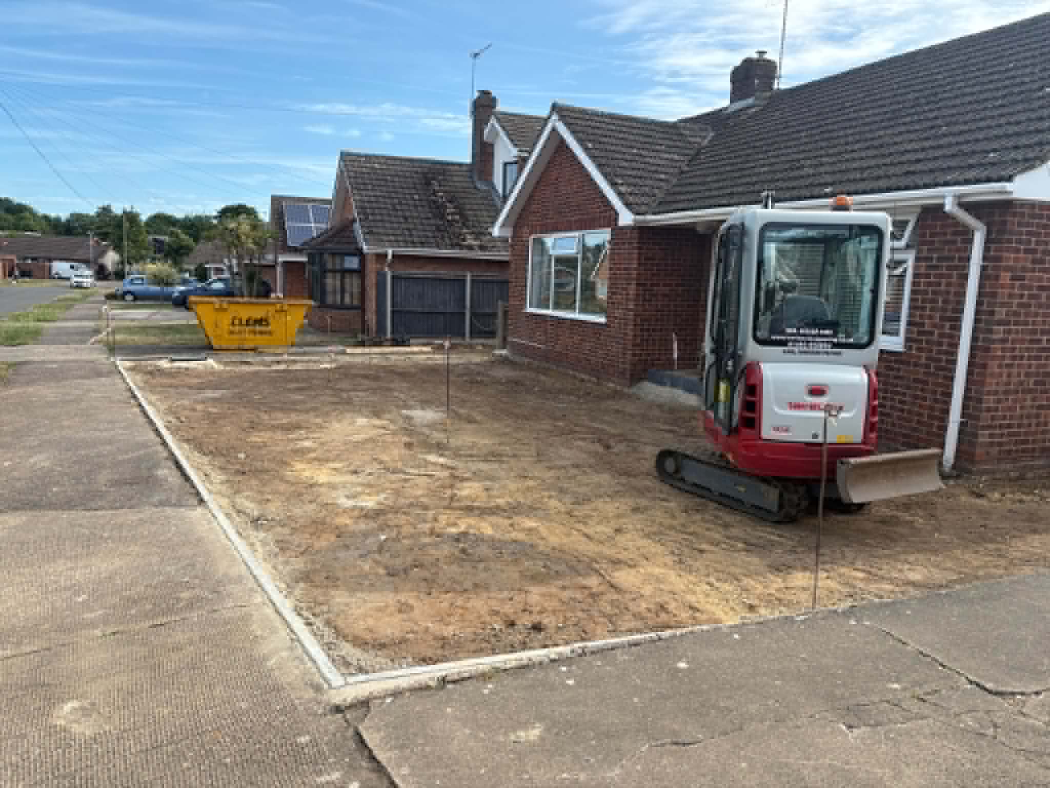 Driveway excavation and ground preparation in progress using a mini digger