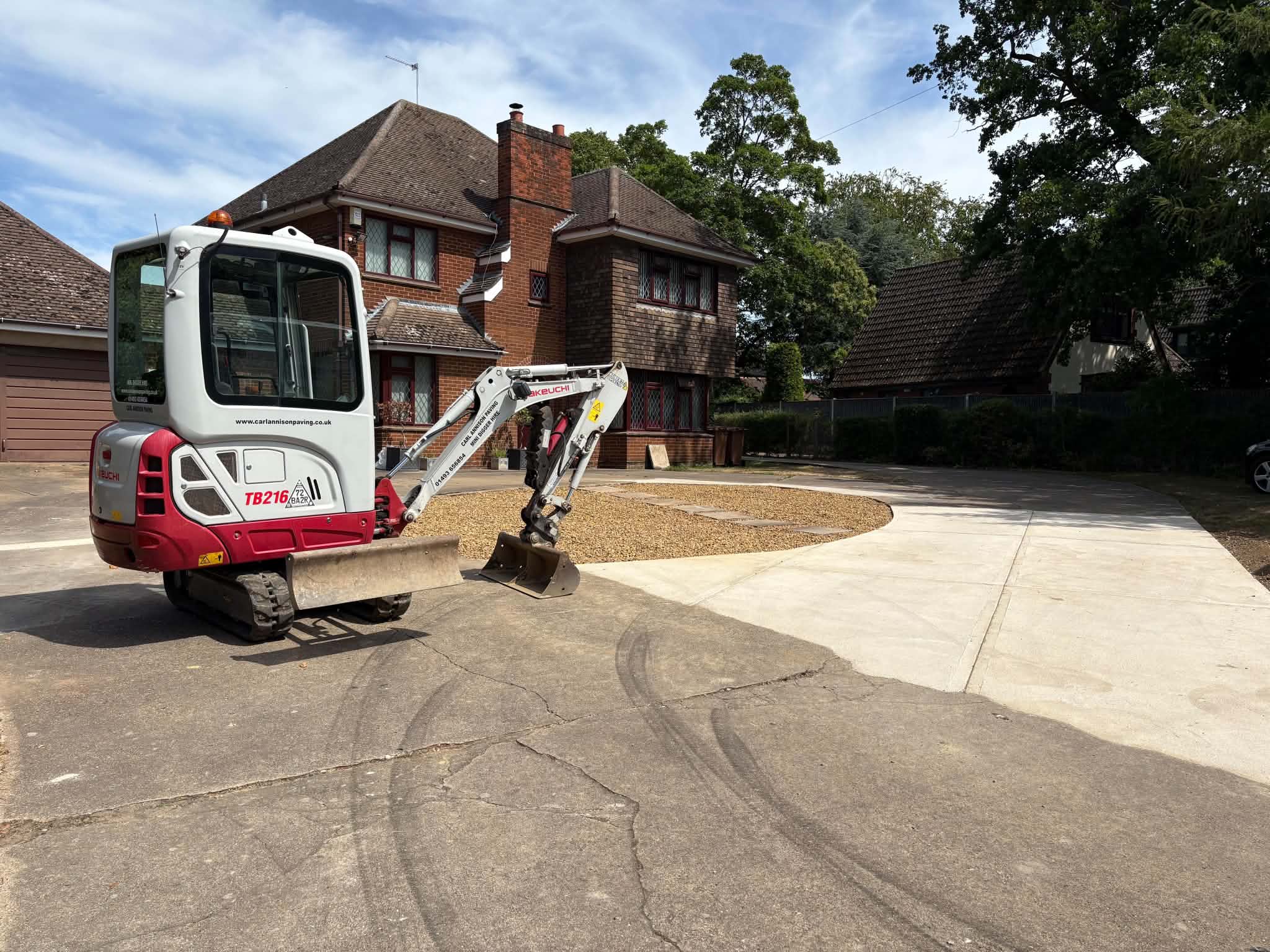 Carl Annison Paving mini digger beside a newly formed driveway with a shingle centre